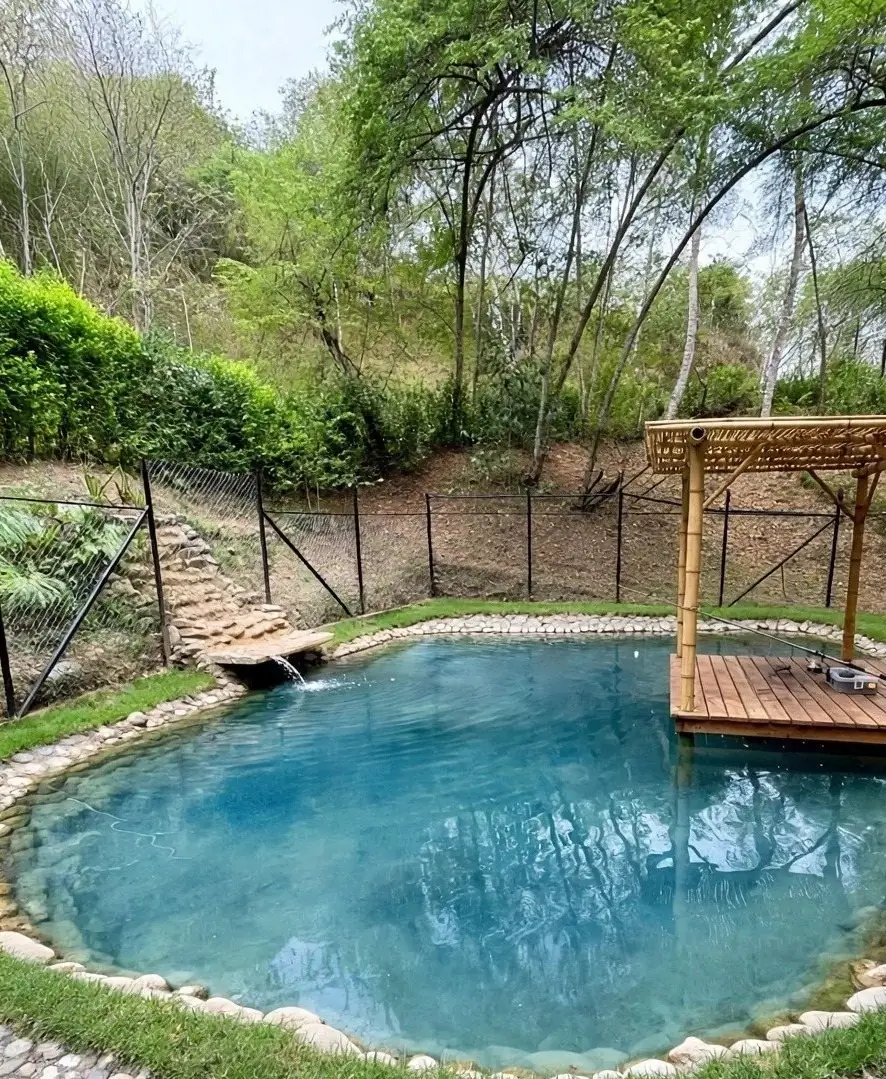 Clear blue pond with a teak dock and a bamboo pergola